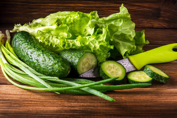 Set for making a salad of fresh herbs cucumbers and onions in drops of water on vintage table