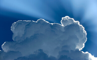 Sunrays Coming Through the Blue Skies Over a Big Cloud