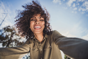 Photo of pretty positive dark skin student take selfie photo recording video good mood toothy smile...