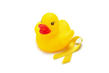 Yellow awareness ribbon and rubber duck isolated on white background