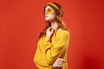 pretty woman wearing glasses yellow sweater emotions casual wear red background