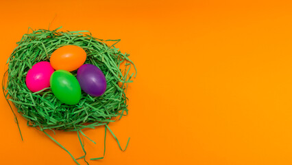 Four Colorful Easter Eggs Sitting in Green nest or Grass