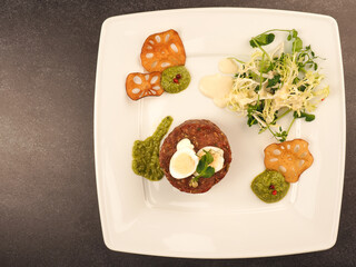 Beef tartare with a quail egg and fresh organic garden salad