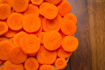 Delicious food background. Raw carrots cut into mugs