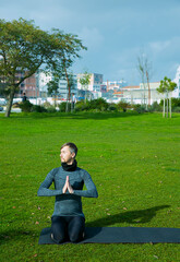 Fototapeta premium Middle aged man doing yoga in the park