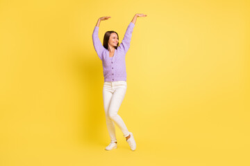 Full length body size view of pretty cheerful girl dancing having fun fooling isolated over bright yellow color background