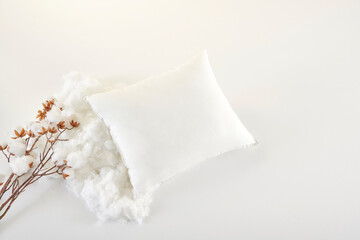 White pillow on the table and close up cotton flower decorative still life.