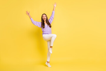Full body photo of young cheerful girl happy positive smile excited wave hello greetings isolated over yellow color background © deagreez