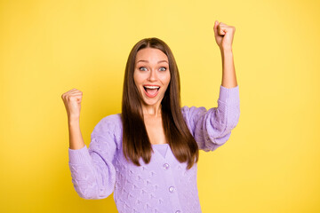 Portrait of attractive cheerful girl rejoicing having fun great luck isolated over bright yellow...