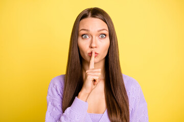 Portrait of attractive worried brown-haired girl showing shh sign mute veto isolated over bright yellow color background