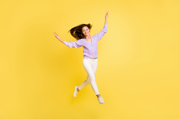 Fototapeta na wymiar Full length body size view of attractive cheerful thin girl jumping running having fun isolated over bright yellow color background