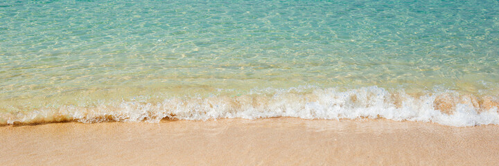 Fototapeta na wymiar Sea with soft waves and sandy beach. Travel, vacation concept. Banner.