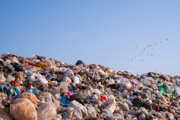large garbage pile, global warming on sky background