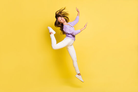 Full length body size view of lovely cheerful girl jumping having fun dancing move ballet isolated over bright yellow color background