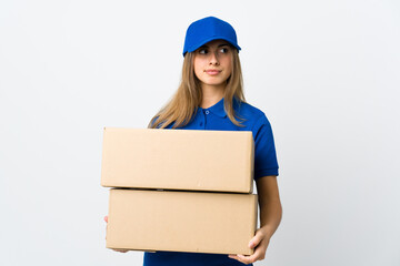 Young delivery woman over isolated white background making doubts gesture looking side