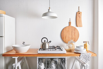 Kitchen utensils on the wall cutting board fork sink lamp style.