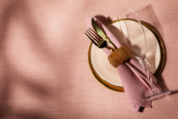 Holiday table setting in pink and golden colors
