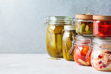 Gordijnen Homemade pickled and fermented vegetables in glass jars, copy space. Home preservation concept. © vaaseenaa