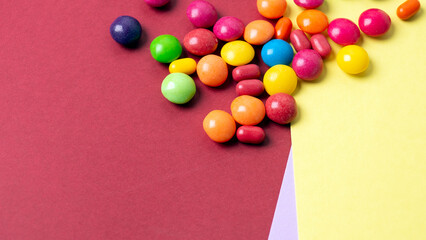 colorful little candies on a colored background