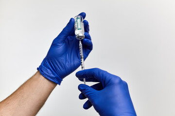 Doctor, nurse hand in blue gloves holding coronavirus covid-19 vaccine