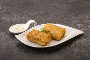 Staffed pancakes served sour cream