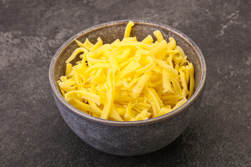 Shredded yellow cheese in the bowl