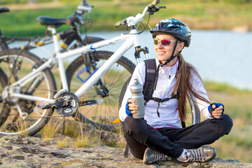 Beautiful bike woman relaxing after  riding