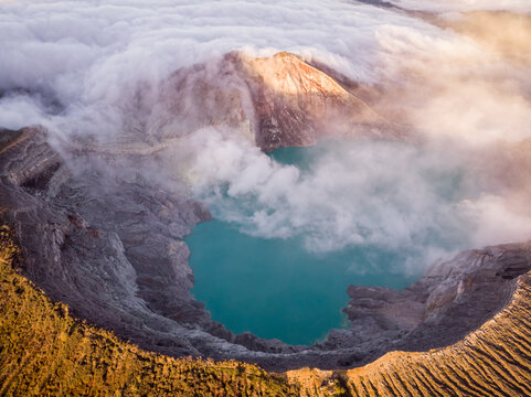 Aerial view of Ijen mountain range with its crater Kawah Ljen, known for its blue flames during a cloudy day, East Java, Indonesia.