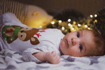 Newborn baby lies and smiles at parents