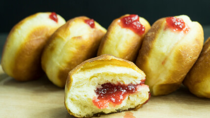 doughnut, donut with filling on a wooden plank, donuts sprinkled with powdered sugar