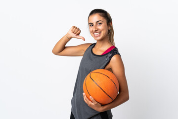 Young hispanic woman playing basketball over isolated white background proud and self-satisfied