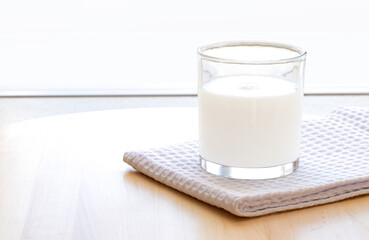 Glass of fermented milk drink on the table
