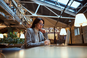 Attentive female person making notes during work