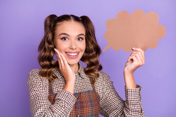 Portrait of impressed positive person hold paper cloud card hand on cheek isolated on purple color background