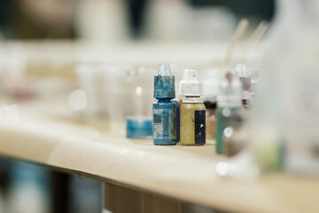 two cans of paint in blue and gold are on the table