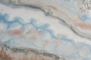 very delicate abstract resin art, flows of milky curves interspersed with silver shimer and winding...