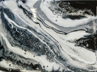 beautiful modern liquid art, imitation of a precious stone. black and white blur by waves, resin with large silver blotches shimmers and mixes with curves, stripes, cells and veins.