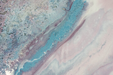 Fototapeta na wymiar background liquid marble of soft pink and blue color. Streams of delicate blues, whites and pinks, meandering metallic curls and colors form the landscape and play from one color to another