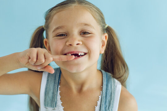 Portrait of preschooler girl with open mouth without milk tooth. High quality photo