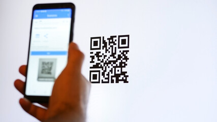 Scan QR code with smartphone on computer monitor. - 414054121
