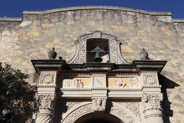 Texture of a rock wall and ornate stonework at the entrance of The Alamo in San Antonio, Texas
