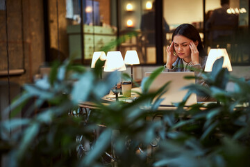 Emotional businesswoman trying to concentrate on task