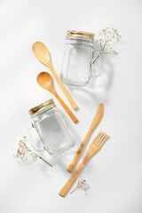 Zero waste, eco friendly concept. Glass jars and bamboo cutlery on white background