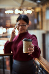 Focused photo on female hand holding her coffee