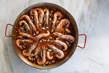 Top view of typical spanish seafood paella in traditional pan