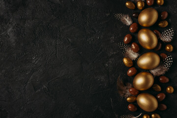 Easter concept card with golden eggs and candy sweet frame falt lay on black background