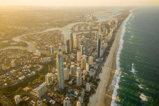 Aerial view of Outdoor Stage theatre along the Nerang river with Gold Coast cityscape in background at sunset, Queensland, Australia.