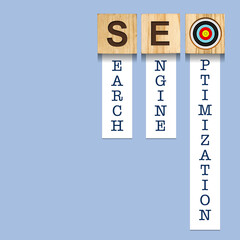 SEO concept. Search engine optimization. Word on wooden blocks, over blue background.