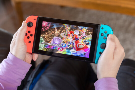 IBBENBUEREN, GERMANY - FEBRUARY 14, 2021: mario kart deluxe 8 popular Nintendo switch with joy controllers family friend activity