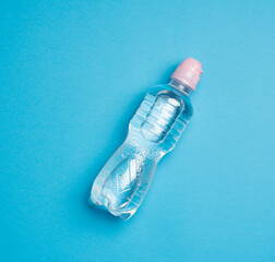 transparent plastic bottle with fresh water on a blue background